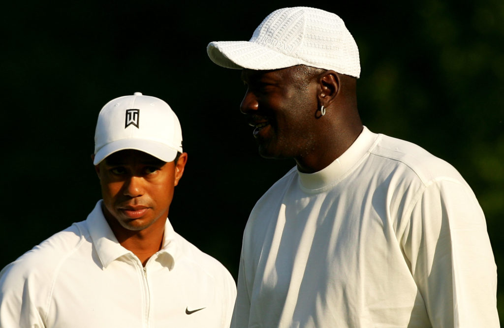 Tiger Woods stands with basketball star Michael Jordan on the 5th green during the Pro-am at the Wachovia Championship at Quail Hollow Country Club