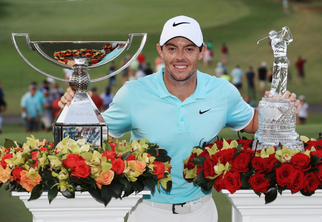 Rory McIlroy poses with the FedExCup and TOUR Championship trophies
