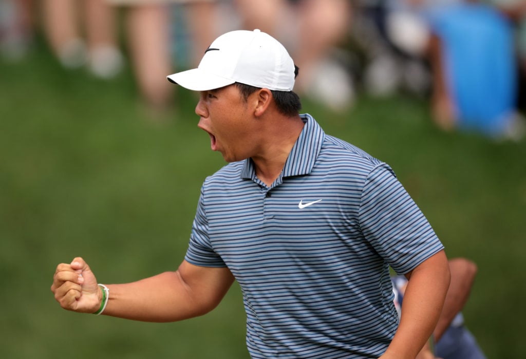 Tom Kim celebrates after holing a putt at the Travelers Championship