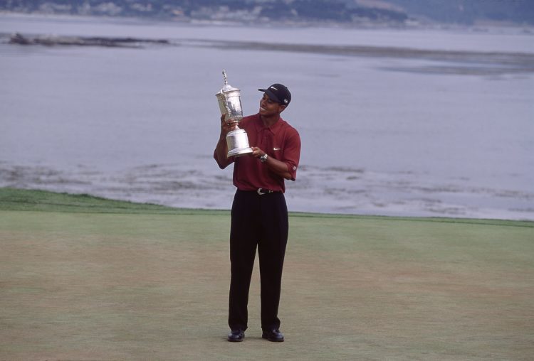 18 Jun 2000:  Tiger Woods of the USA poses with the winning trophy after winning the 100th US Open held at the Pebble Beach Golf Links, in Pebble B...