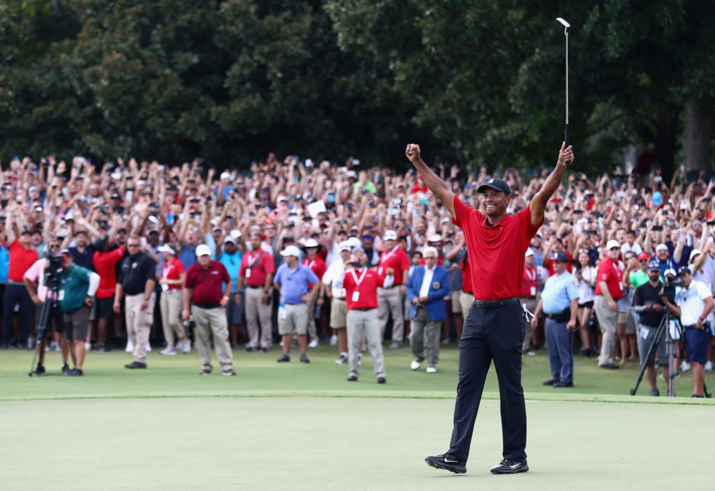 Tiger Woods of the United States celebrates making a par on the 18th green to win the TOUR Championship at East Lake Golf Club
