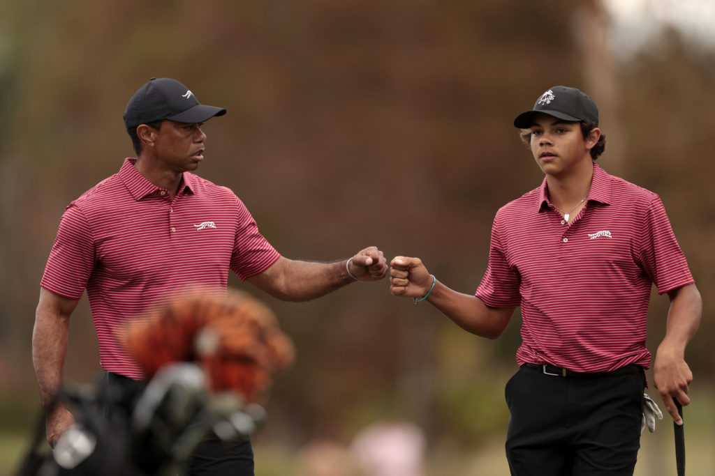 Tiger Woods of the United States and his son Charlie Woods react on the 16th green during the second round of the PNC Championship at Ritz-Carlton Golf Club on December 22, 2024