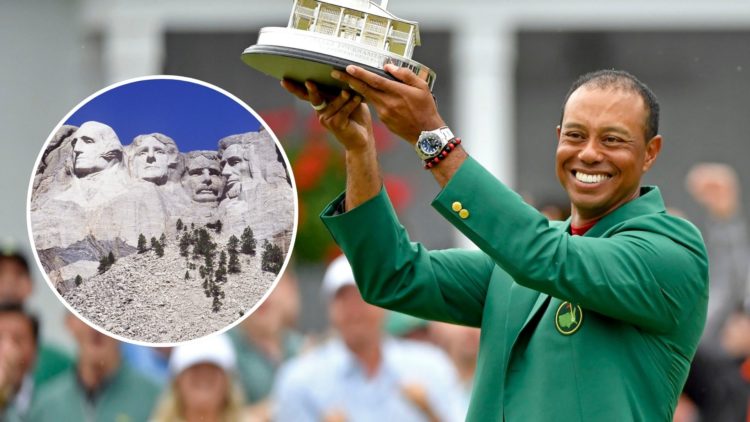 Masters champion Tiger Woods holds up the trophy during the Green Jacket Ceremony following the final round of the Masters at Augusta National Golf...