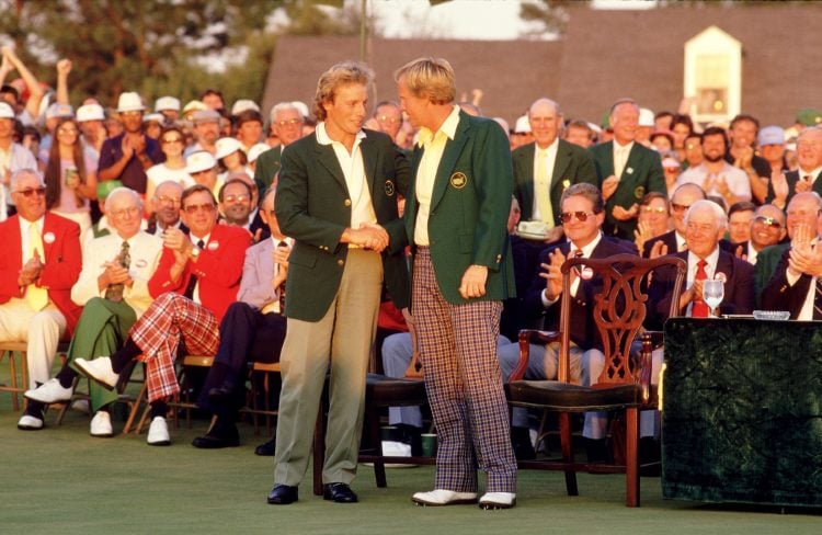 13 Apr 1986:  Jack Nicklaus of the USA receives the Green Jacket from previous winner Bernhard Langer of Germany after victory in the US Masters at...