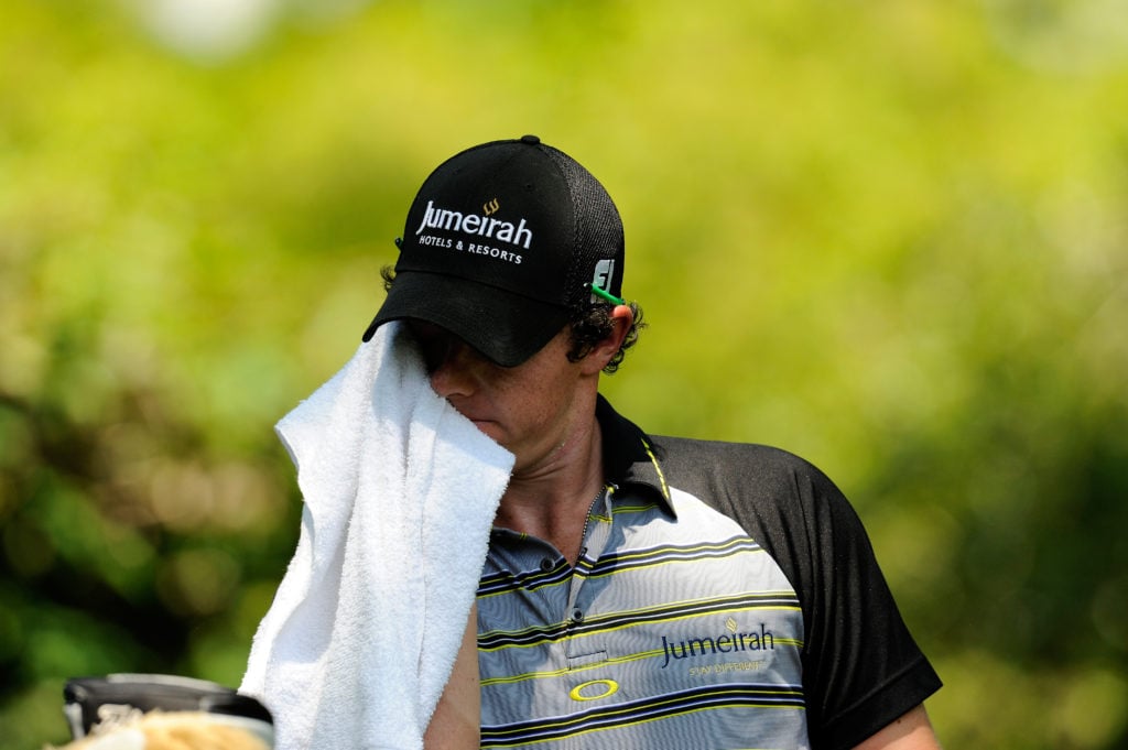 Rory McIlroy with his head in a towel after the 2011 Masters