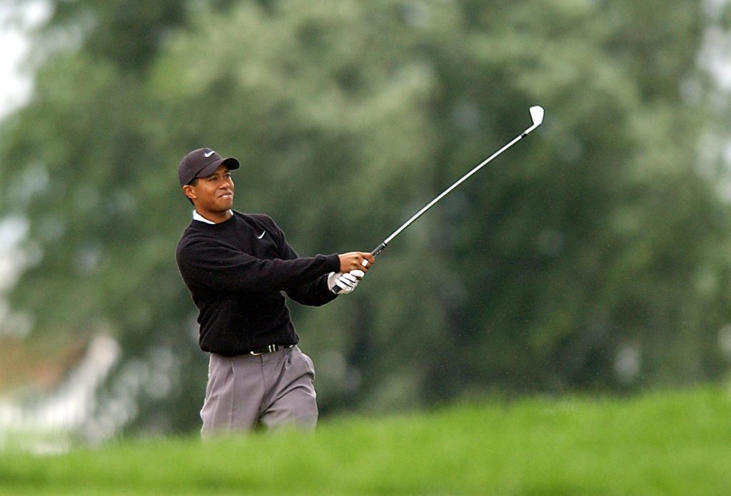 Tiger Woods of the US watches his bunker shot at the 2002 PGA Championship