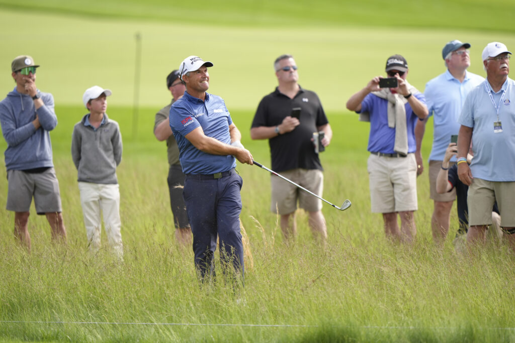 Padraig Harrington hits his shot for the rough at the Senior PGA Championship