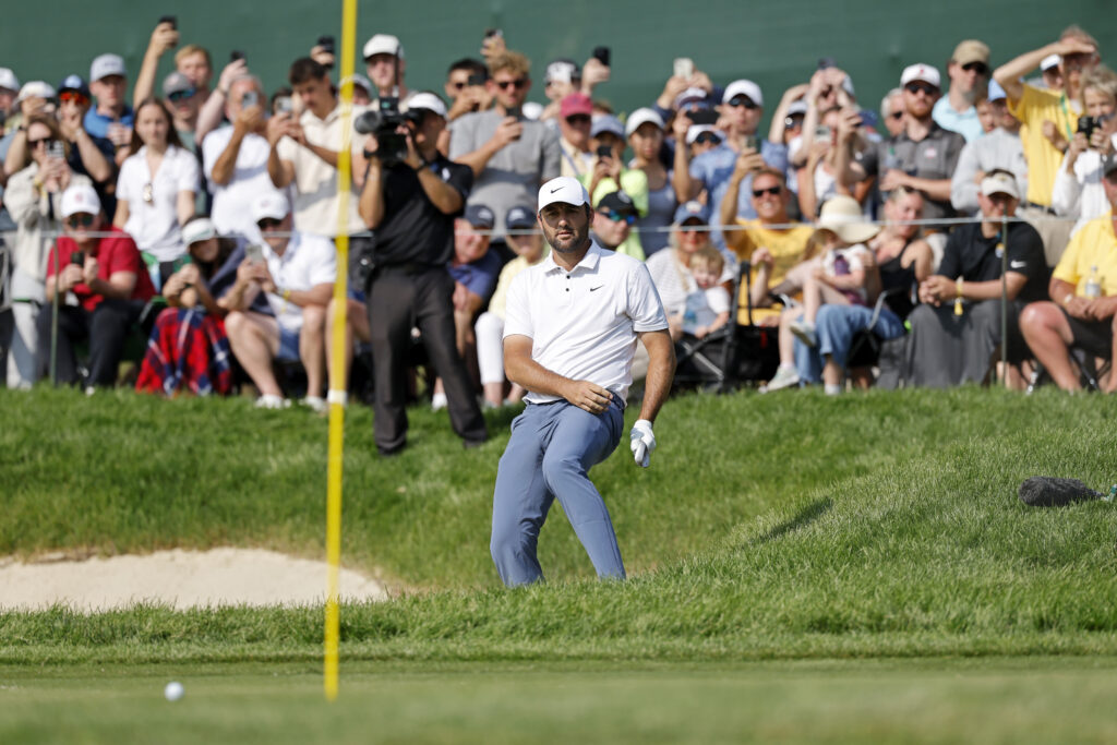 Scottie Scheffler plays out of a bunker at The Memorial Tournament