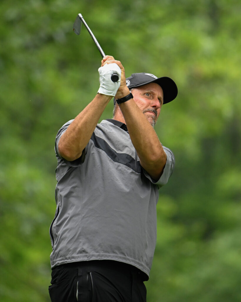 Phil Mickelson hits an iron shot on day three of LIV Golf Virginia