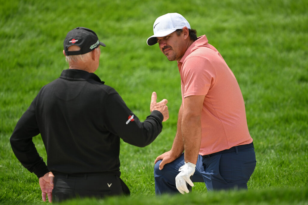 Brooks Koepka talking with Pete Cowen in practice ahead of the 2025 US Open