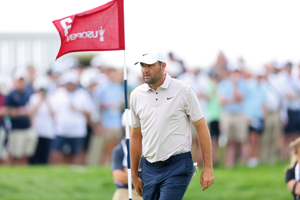 Scottie Scheffler walks across the third green during a practice round at the US Open