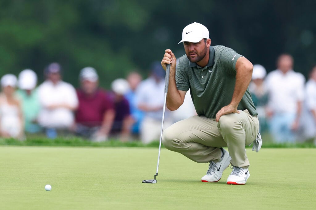 Scottie Scheffler lines a putt up during round two of the US Open at Oakmont