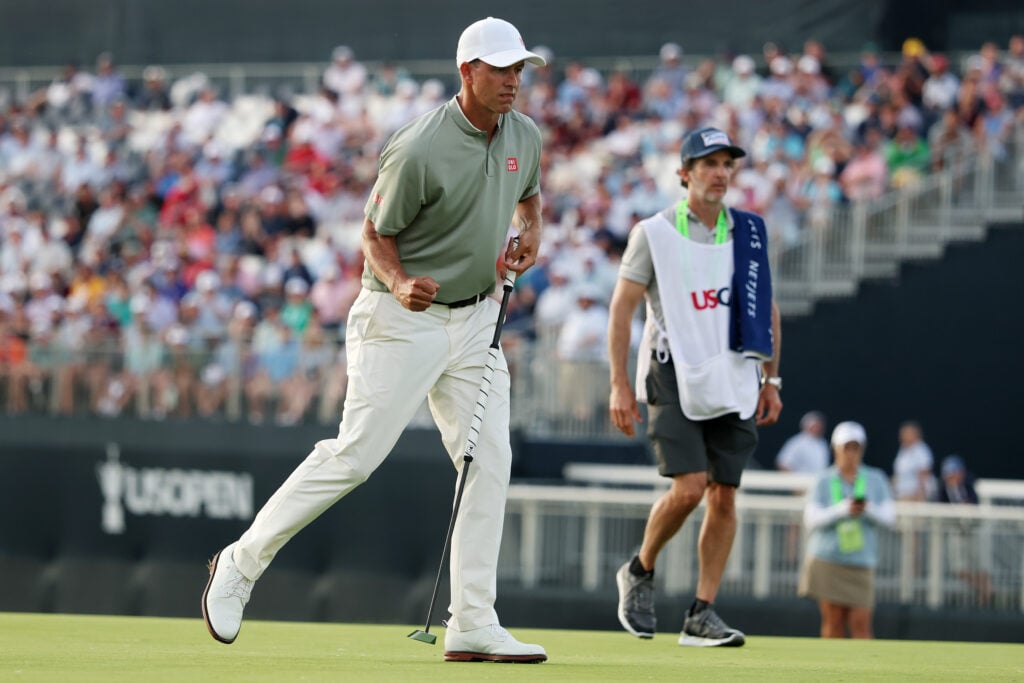 Adam Scott reacts after making a putt in the third round of the US Open