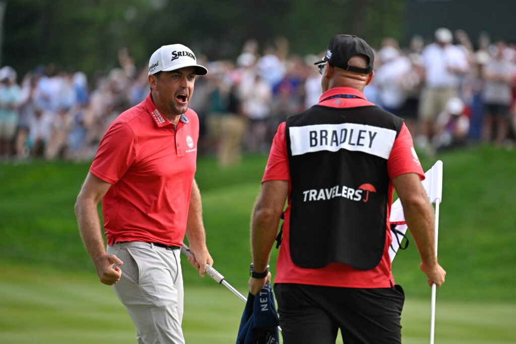 Keegan Bradley celebrates with his caddie Scott Vail after winning the Travelers Championship at TPC River Highlands