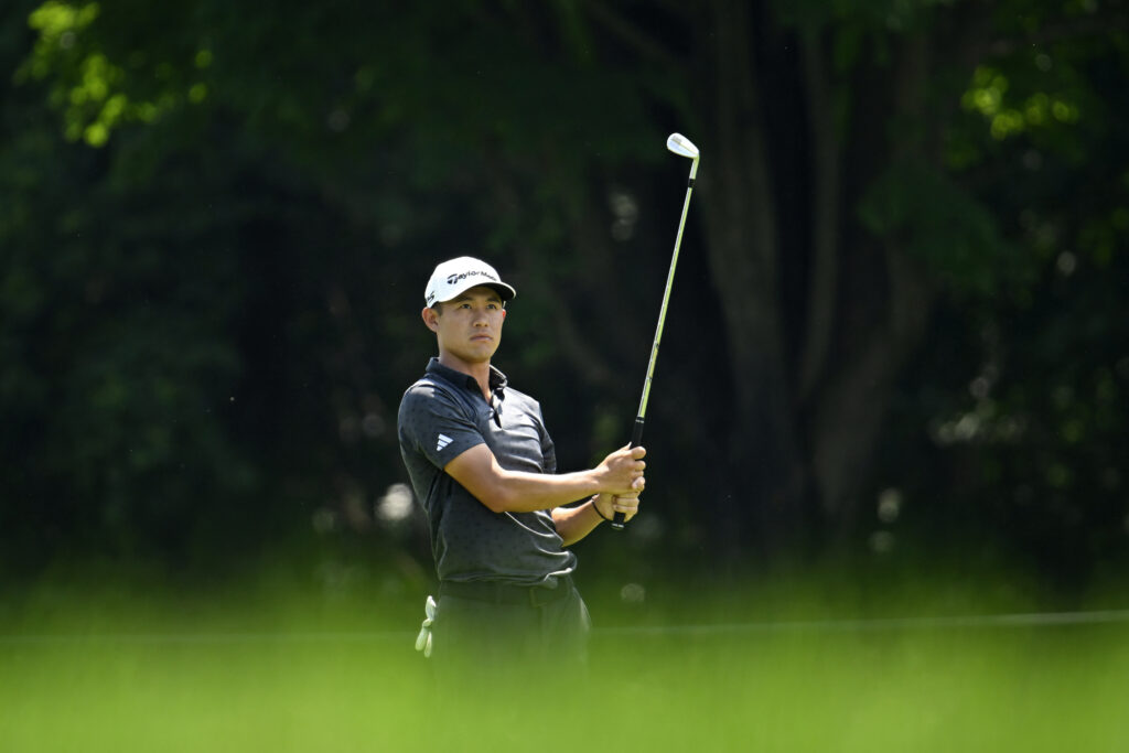Collin Morikawa hits an iron shot with no gloves during round one of The Travelers