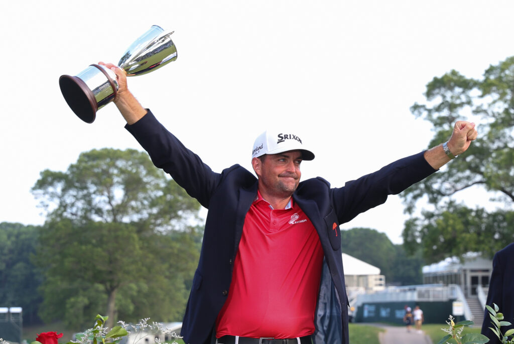 Keegan Bradley lifts the trophy after winning the Travelers Championship