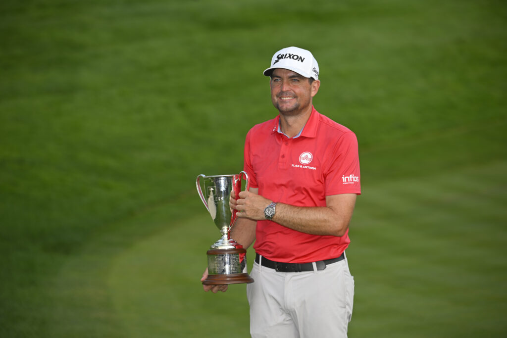 Keegan Bradley holds his trophy after winning the Travelers Championship