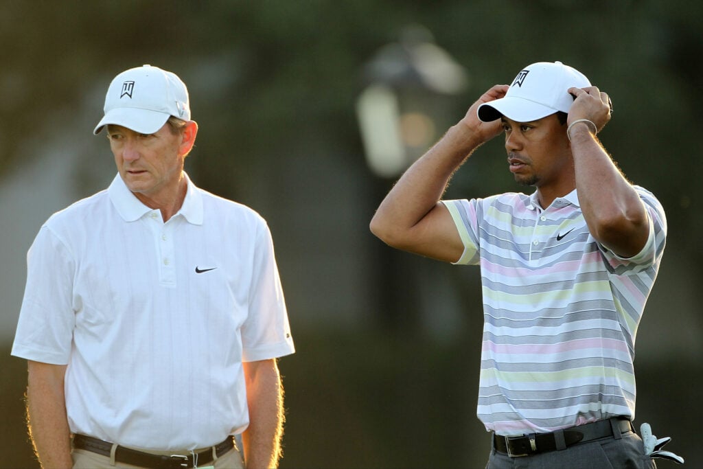 Hank Haney walks alongside Tiger Woods during a practice round at Augusta National ahead of The Masters