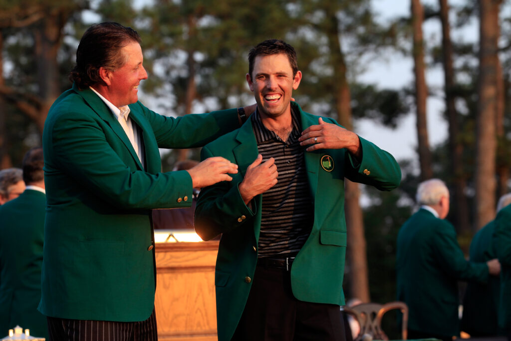 Phil Mickelson presents Charl Schwartzel with his green jacket after his Masters victory in 2011