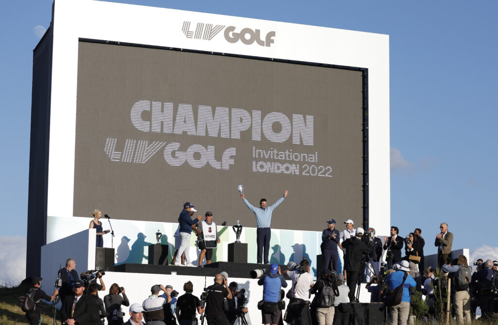 Charl Schwartzel celebrates on the podium after winning LIV Golf Invitational London in 2022