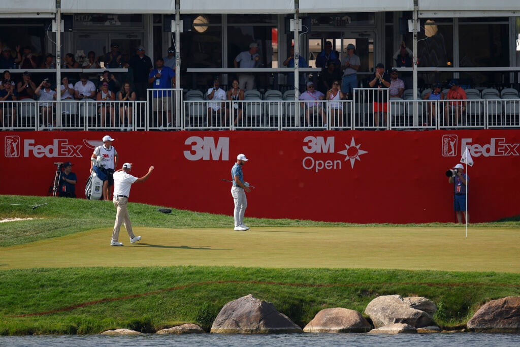 Matt Kuchar acknowledges the crowd after holing out on the 18th hole at the 3M Open