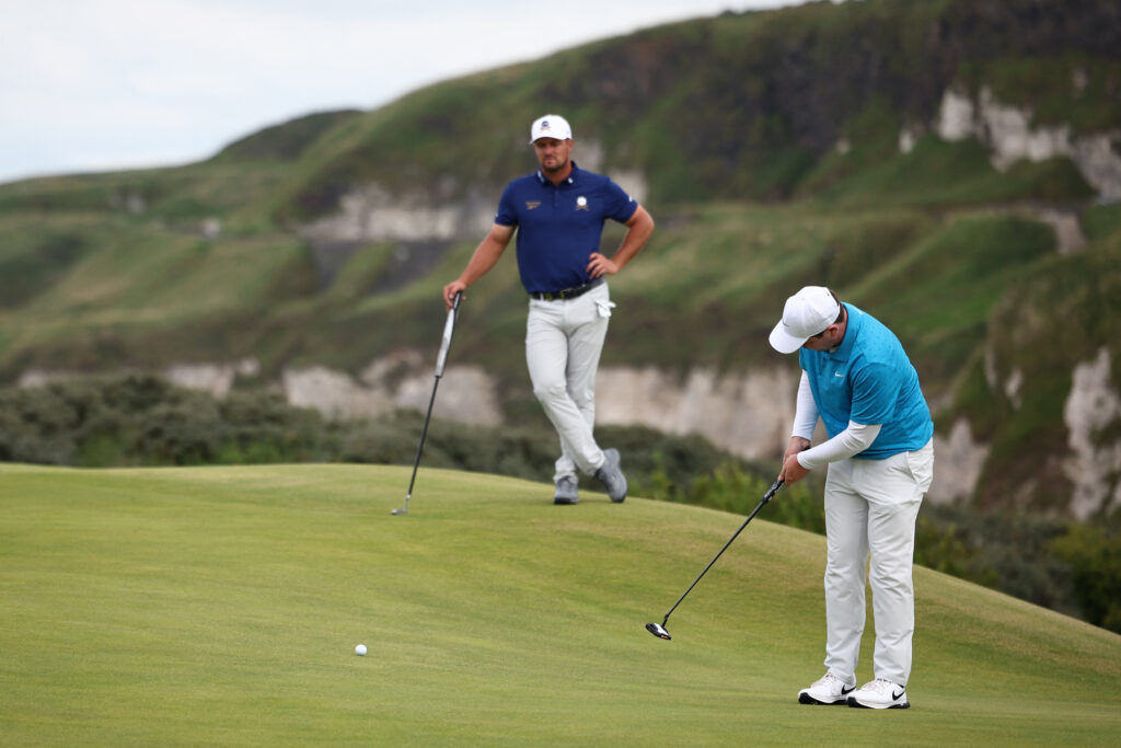 Bryson DeChambeau watches Robert MacIntyre putt on the 5th green on the opening day of the 153rd Open Championship
