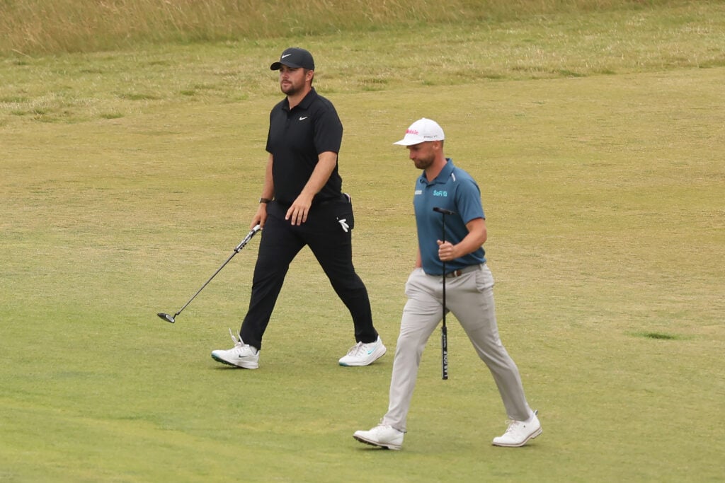 Chris Gotterup walks alongside Wyndham Clark during the fourth round of the Genesis Scottish Open 2025