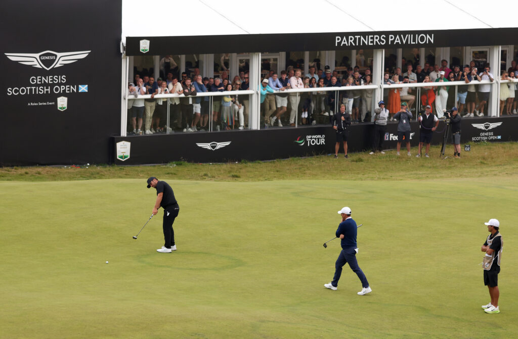 Chris Gotterup putts on the final green alongside Rory McIlroy in the last round of the Genesis Scottish Open at The Renaissance Club.