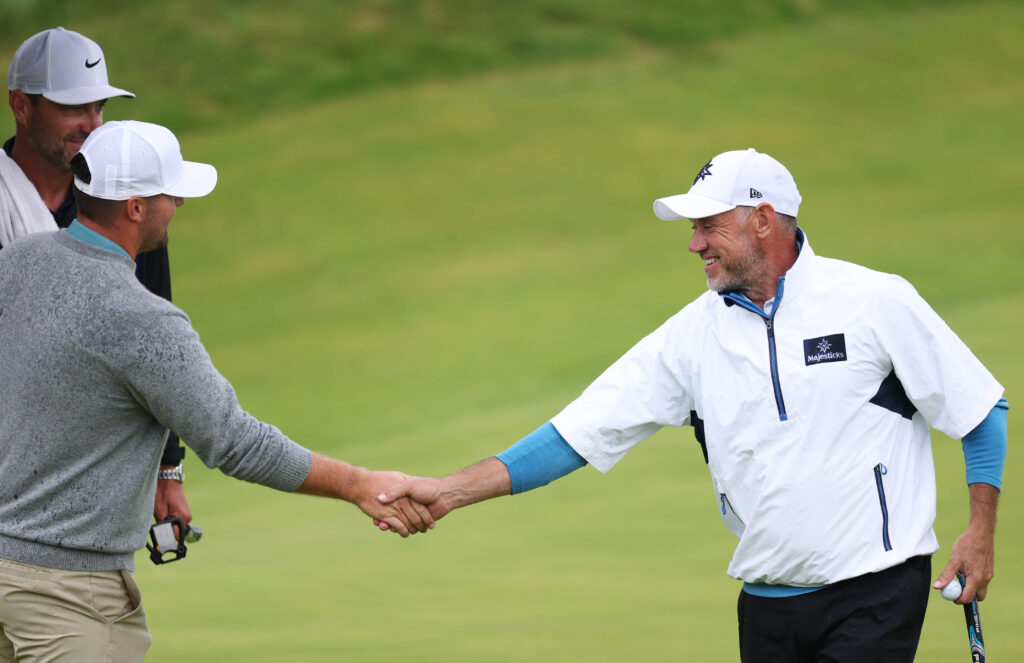 Lee Westwood shakes hands with Chris Gotterup during round two of The Open Championship at Royal Portrush