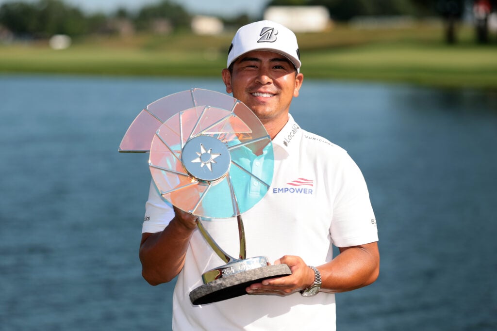 Kurt Kitayama holding the 3M Open trophy after winning the event