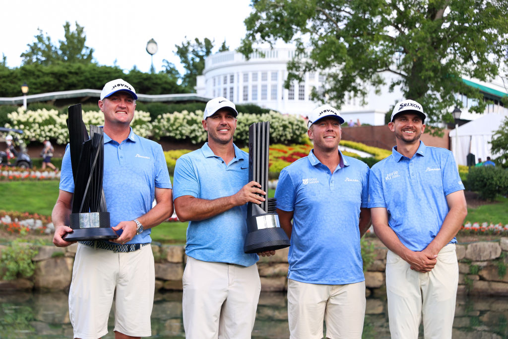 Jason Kokrak, Brooks Koepka, Talor Gooch, and John Catlin stand with the team trophy after Smash GC wins the team championship during day three of LIV Golf Greenbrier