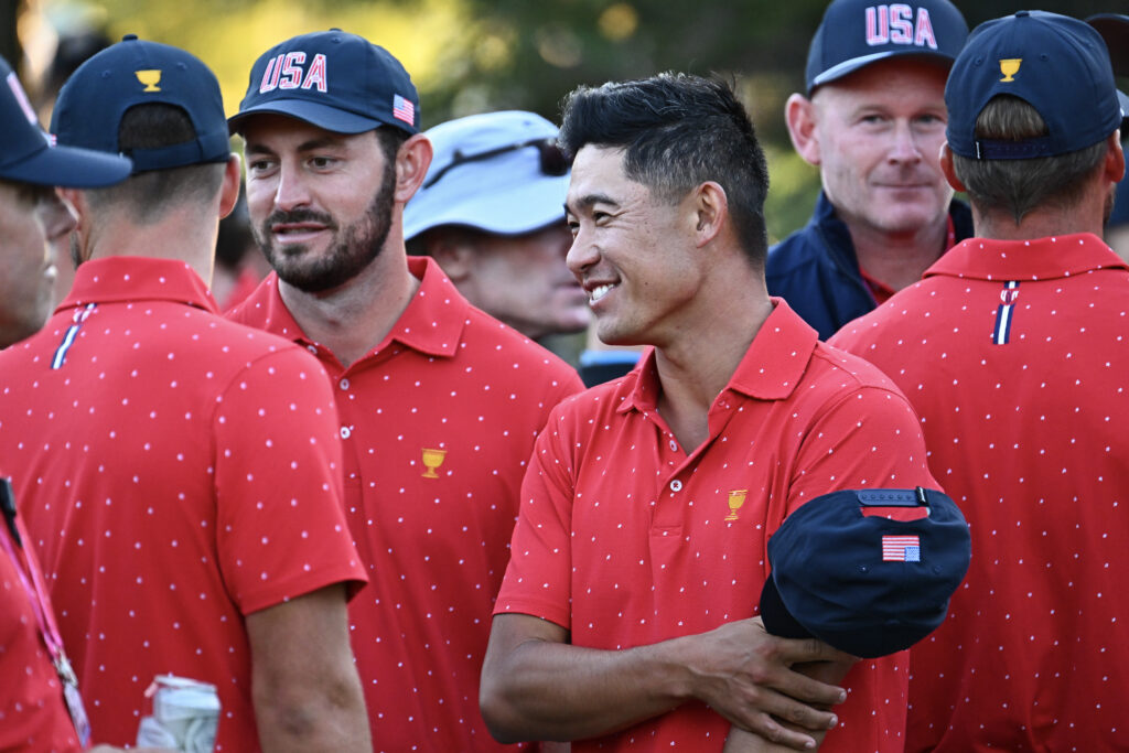 Collin Morikawa and Patrick Cantlay of the US team talk to each other