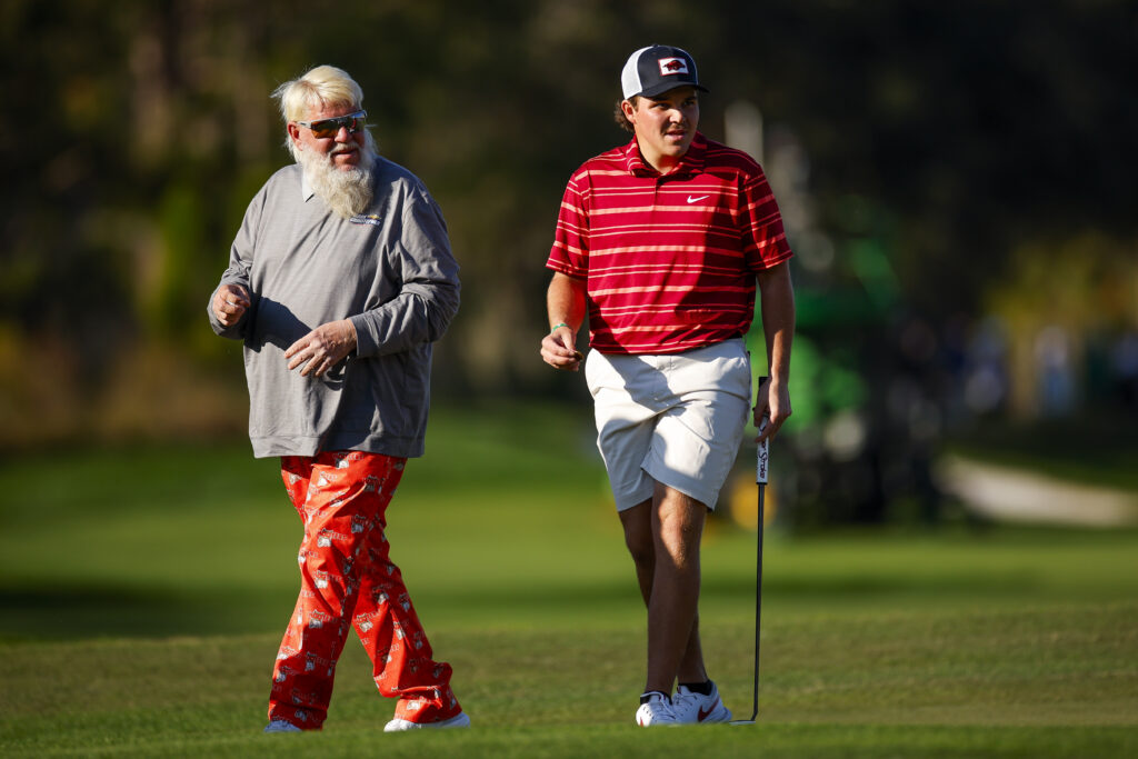 John Daly and his son John Daly II look over a putt on the 18th hole during the first round of the PNC Championship