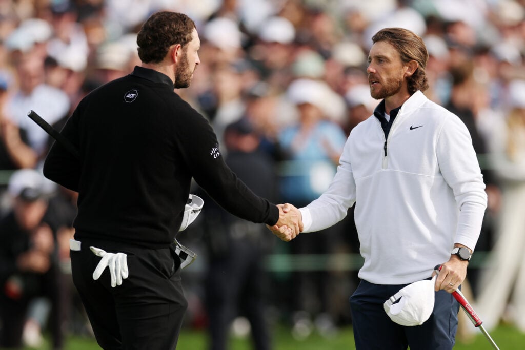 Patrick Cantlay and Tommy Fleetwood shake hands on the 18th green during the final round of The Genesis Invitational at Torrey Pines