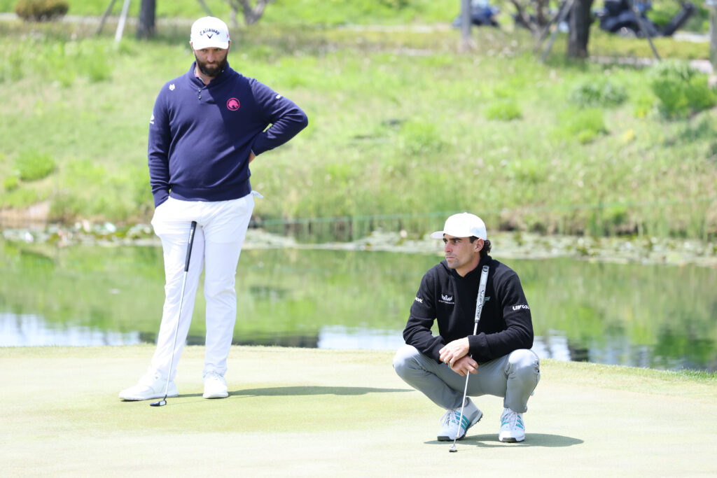 Jon Rahm and Joaquin Niemann wait on the green at LIV Golf Korea