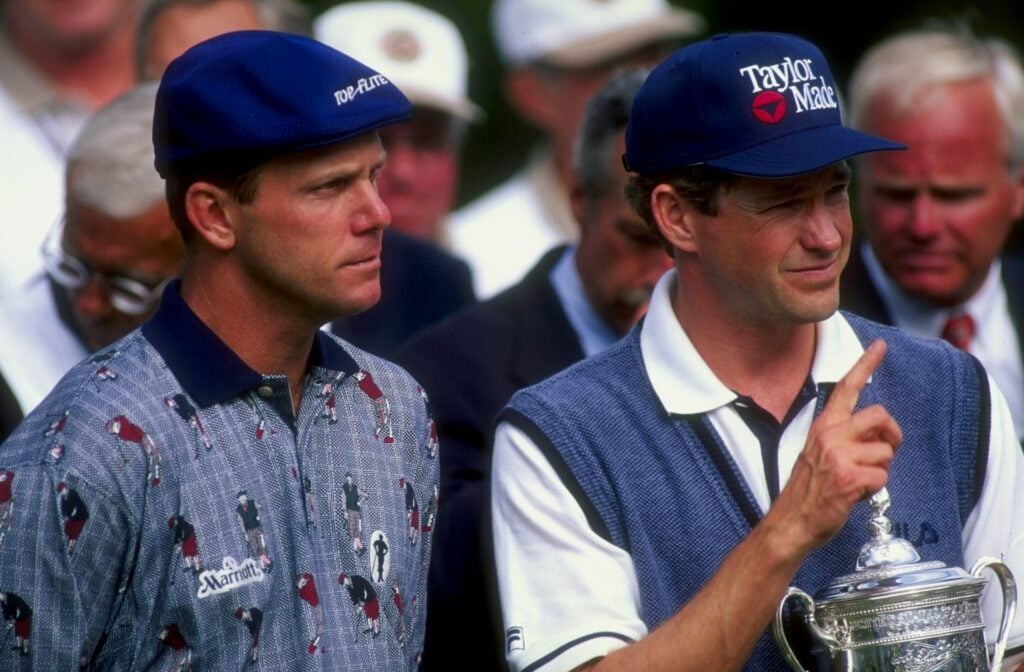 Lee Janzen poses with the US Open trophy as Payne Stewart looks on