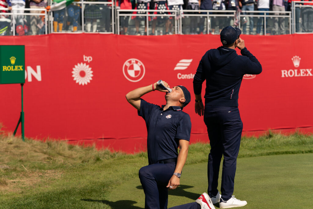 Justin Thomas and Daniel Berger drink beers on the first tee during the 2021 Ryder Cup