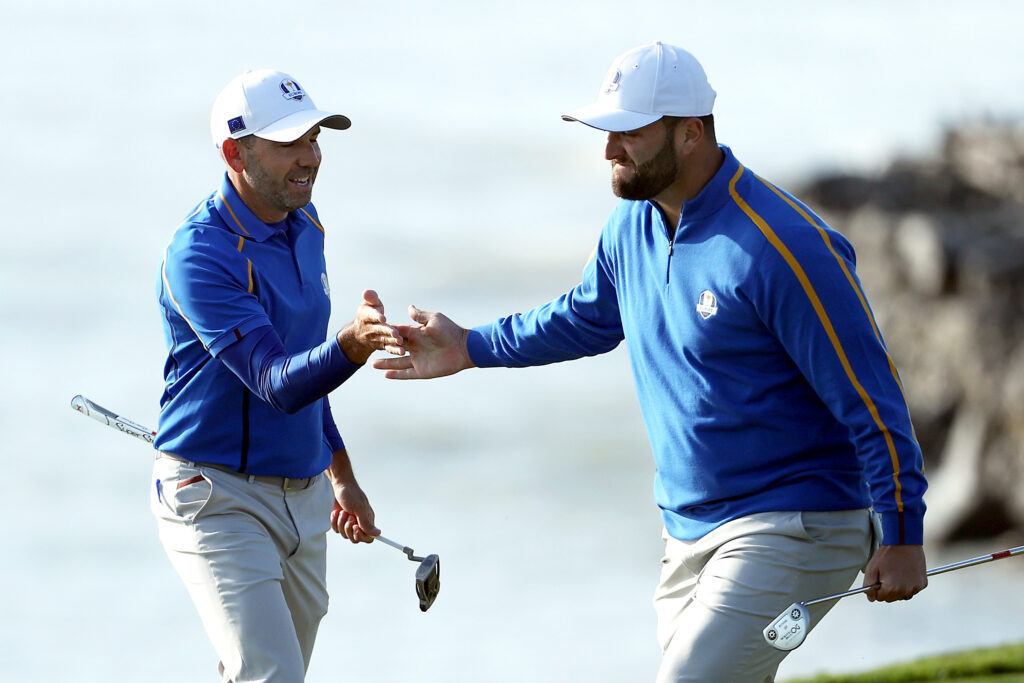 Sergio Garcia and Jon Rahm of team Europe celebrate on the eighth green after winning the hole during Friday Morning Foursomes