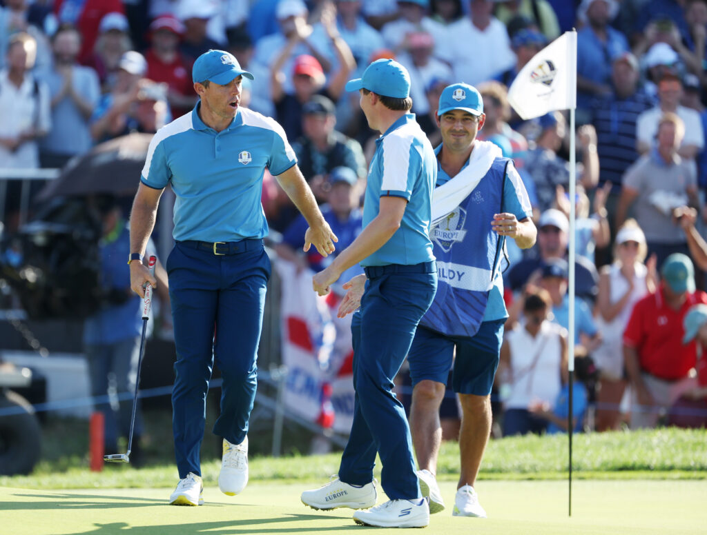 Rory McIlroy and Matthew Fitzpatrick celebrate winning a hole during the second session at the 2023 Ryder Cup