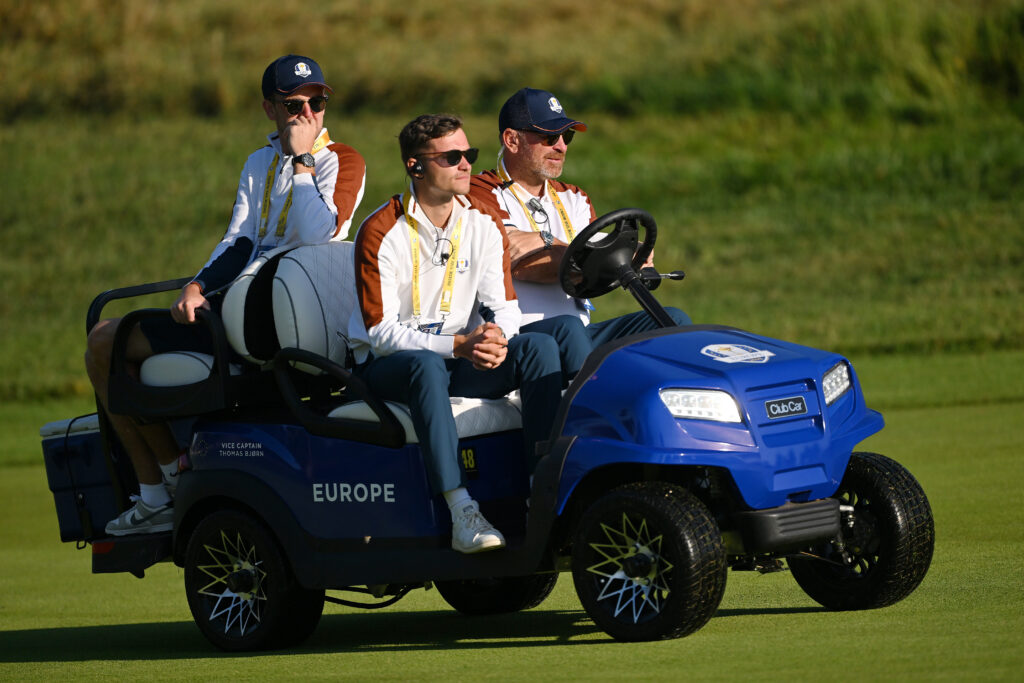 Thomas Bjorn, Vice Captain of Team Europe and Rasmus Hojgaard look on from a Club Car buggy during the Saturday morning foursomes matches of the 2023 Ryder Cup
