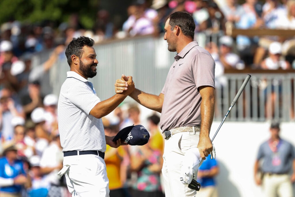 J.J. Spaun shakes hands with Scottie Scheffler on the 18th hole green after they finished their round during the final round of the FedEx St. Jude Championship