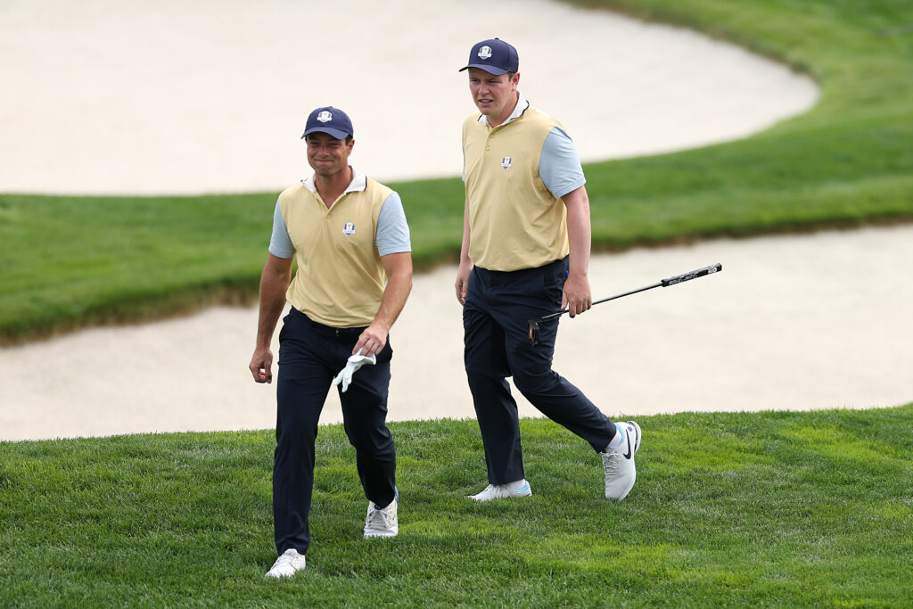 Viktor Hovland and Robert MacIntyre of Team Europe walk to the green prior to the Ryder Cup 2025