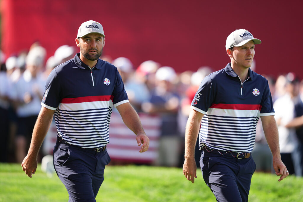 Scottie Scheffler and Russell Henley walk off the 15th tee during the Friday foursomes matches of the 2025 Ryder Cup at Bethpage Black