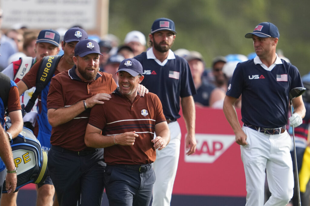 Shane Lowry and Rory McIlroy walk off the 15th tee box together during the four-balls matches on day two of the Ryder Cup at Bethpage Black