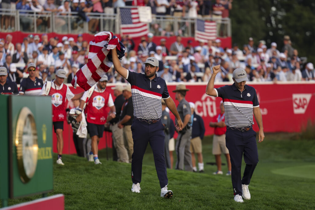 Scottie Scheffler and Russell Henley approach the first tee during the Friday morning foursomes matches of the 2025 Ryder Cup