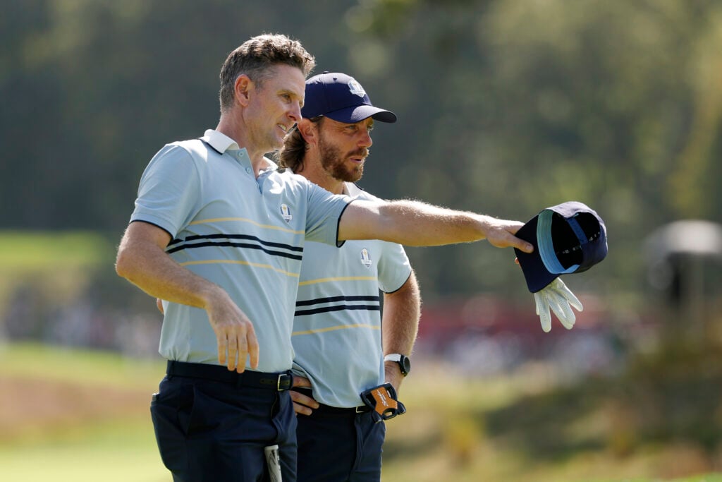 Justin Rose talks with teammate Tommy Fleetwood on the fifth hole during the Friday afternoon four-ball matches of the 2025 Ryder Cup