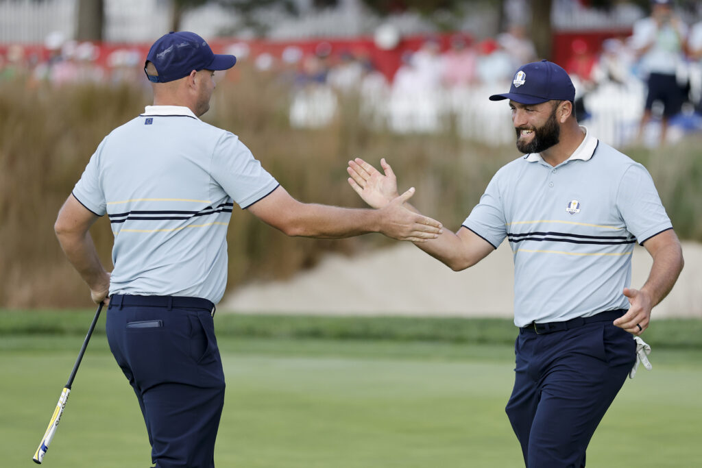 Sepp Straka and Jon Rahm of Team Europe celebrate on the 16th hole after Straka made a birdie to defeat J.J. Spaun and Scottie Scheffler of Team United States