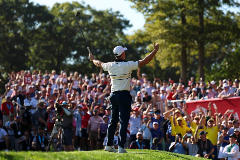 Rory McIlroy of Team Europe holds his arms out to fans at the 2025 Ryder Cup.