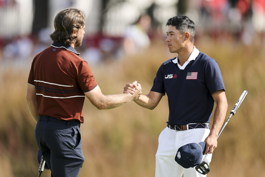 Collin Morikawa and Tommy Fleetwood shake hands after their match on Saturday morning at the Ryder Cup