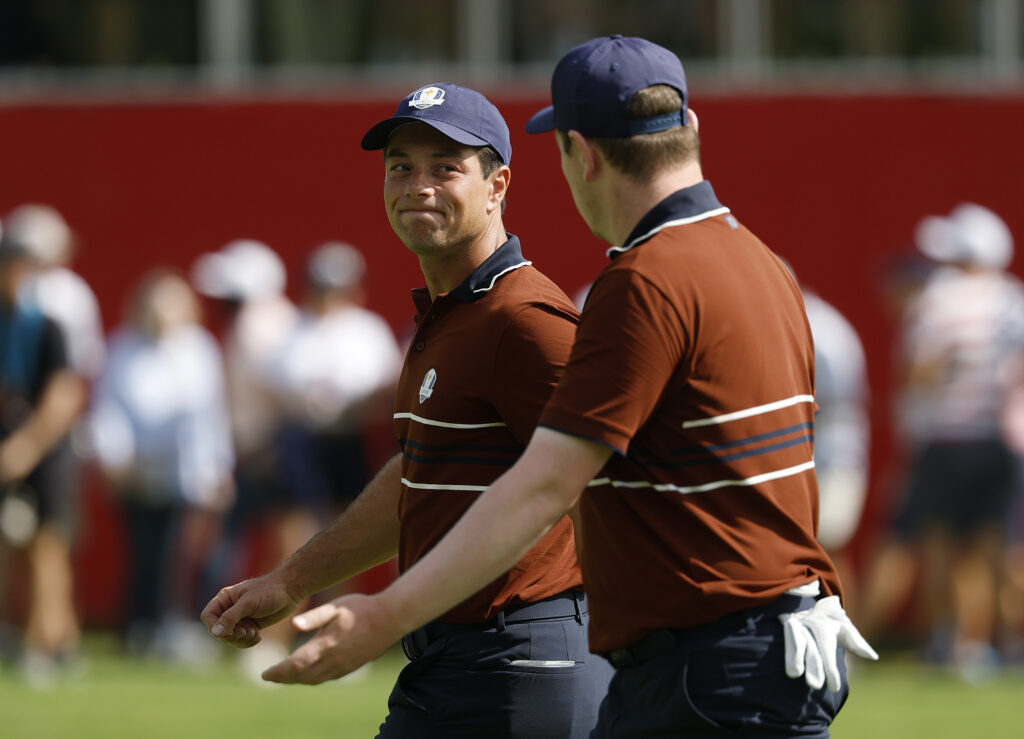 Viktor Hovland talks with Robert MacIntyre during their match on Saturday morning at the Ryder Cup